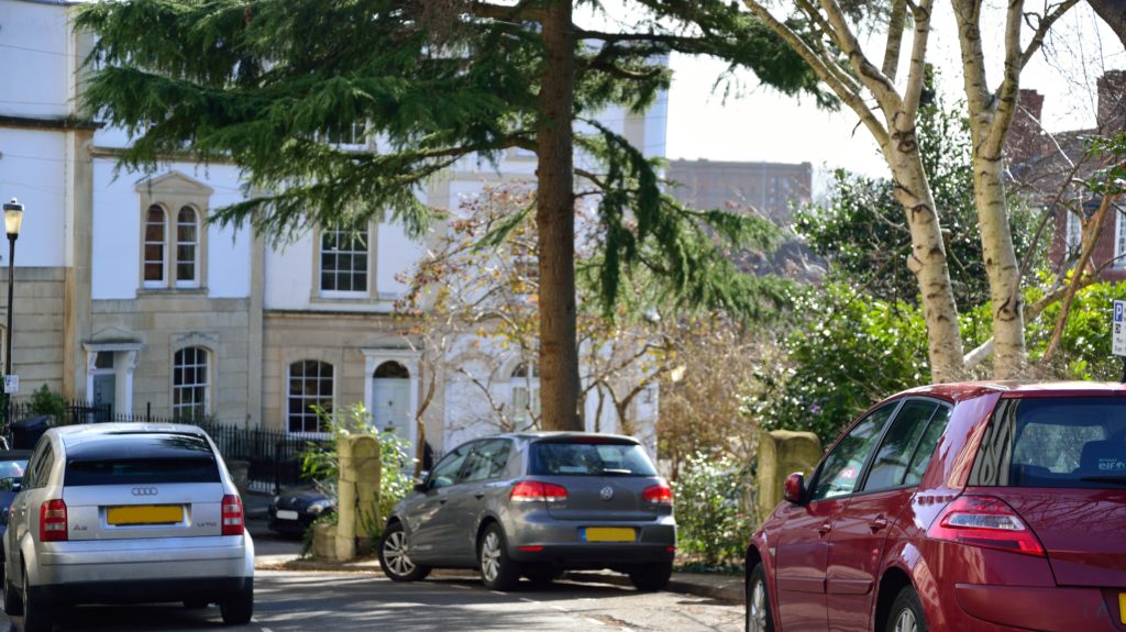 Cars parked on suburban road