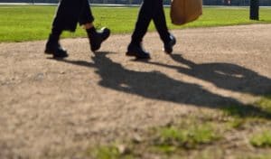 Cropped photo of people walking on a path