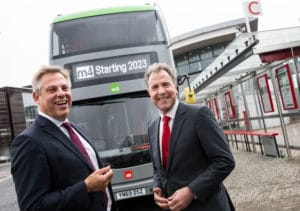 Doug Claringbold and Metro Mayor Dan Norris standing in front of metrobus bus showing m4 Starting 2023 in the digital sign