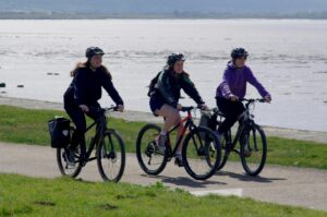 3 people cycling