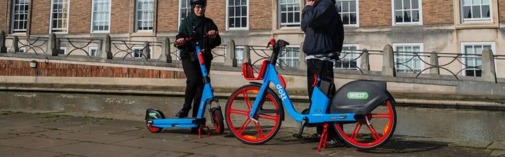An electric bike and scooter in the new red and blue branded livery by Dott