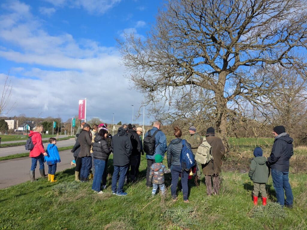 Photo of the walk leader and participants, gathered around an old English Oak tree.