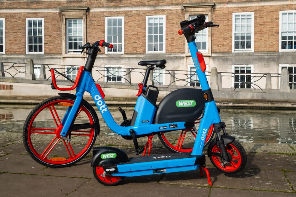 An electric bike and scooter in the new red and blue branded livery by Dott