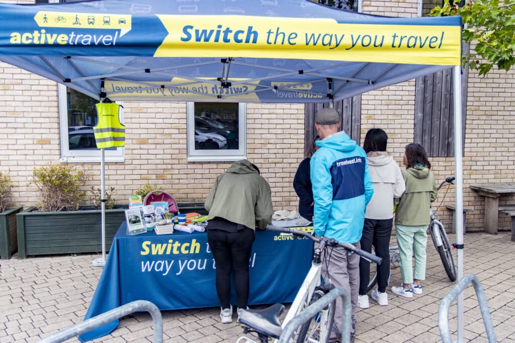 Photo of people gathered around the active travel roadshow team stall.