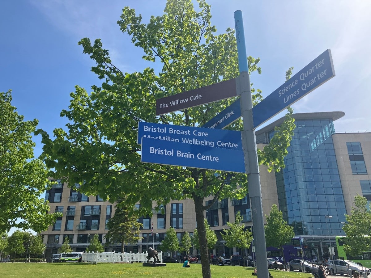 Signposts outside Southmead Hospital in Bristol directing visitors to the Bristol Breast Care Centre, Bristol Brain Centre, Bristol Dental Hospital and The Willow Cafe.